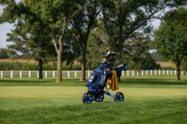 A women's golfer follows through on a drive during a round