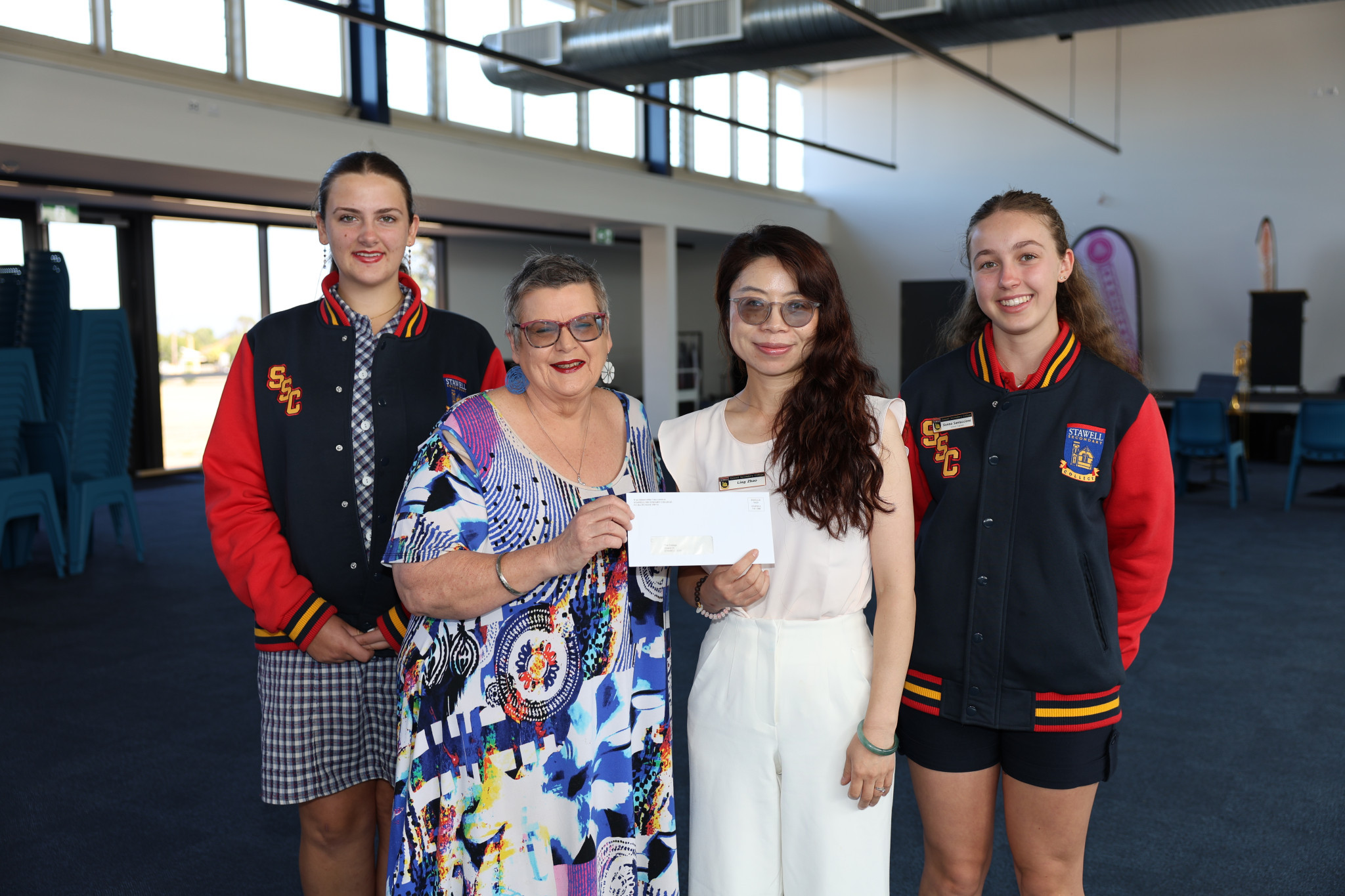 Mary Rita Thomas from The Cottage in Stawell, receives a cheque from Stawell Secondary College VCE coordinator and Chinese Faculty leader Ling Zhao, and school captains Chloe Formosa (left) and Sienna Santuccione (right).