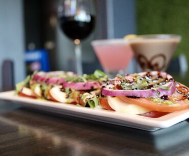 The Tomato Caprese ($9.99) is made with tomato, mozzarella, red onion, pesto and balsamic glaze. (Jovanna Aguilar/Community Impact)