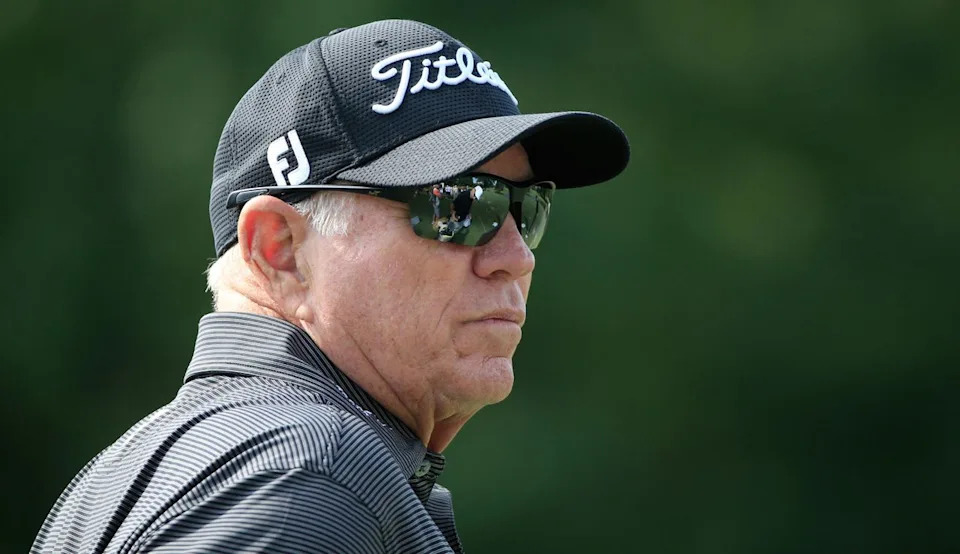  Harmon stares with sunglasses on. 