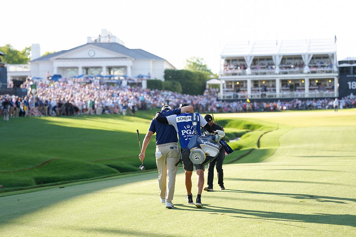 Scheffler strode down the 18th fairway arm in arm with caddie Ted Scott after his approach shot