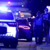 Federal and local law enforcement officers investigate a suspect’s vehicle on South Capitol Street in Washington, D.C., on August 11.