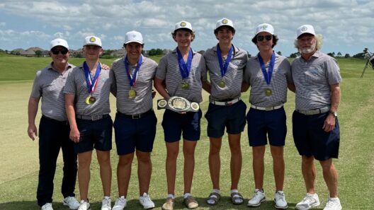 Coaches and player on the Kelly Catholic team pose for a picture after winning the TAPPS 5A South Regional.