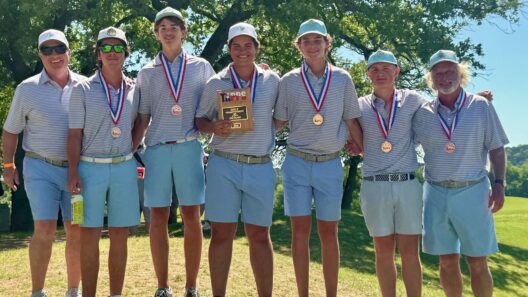 Players and coaches from the Kelly Catholic golf team pose for a picture after their third-place finish at the TAPPS 5A State Championship event.