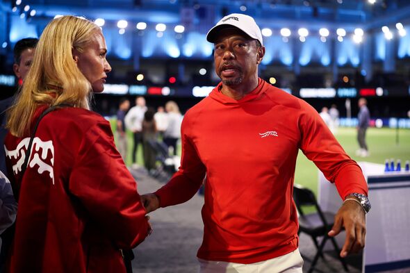 Tiger Woods talks with his girlfriend, Vanessa Trump