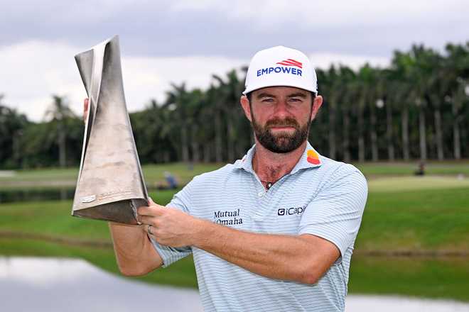 DORAL, FLORIDA - MAY 03: Cameron Young of the United States poses with the trophy after winning the the final round of the Cadillac Championship 2026 at Trump National Doral Miami on May 03, 2026 in Doral, Florida. (Photo by Orlando Ramirez/Getty Images)