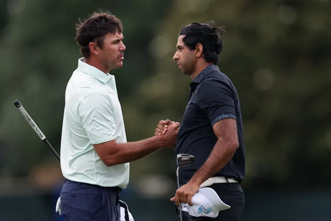 Brooks Koepka and Aaron Rai shake hands on the ninth green after the completed their second round of the 2026 Oneflight Myrtle Beach Classic at Dunes Golf & Beach Club.
