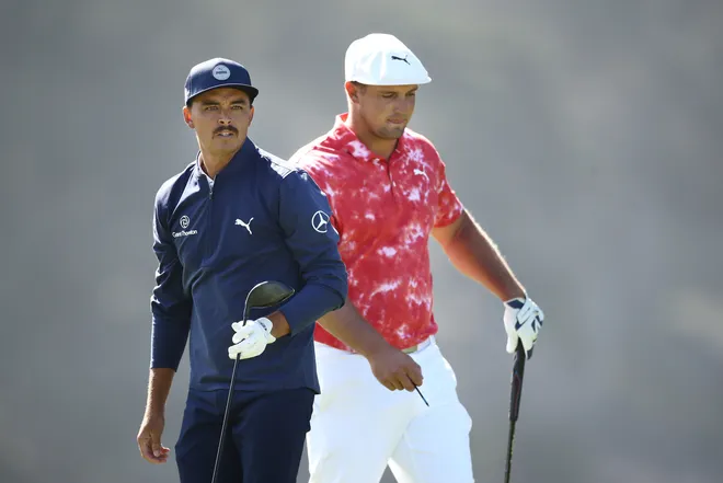 Rickie Fowler of the United States watches his shot from the 16th tee as Bryson DeChambeau of the United States looks on during the second round of the 2020 PGA Championship at TPC Harding Park on August 07, 2020 in San Francisco, California.
