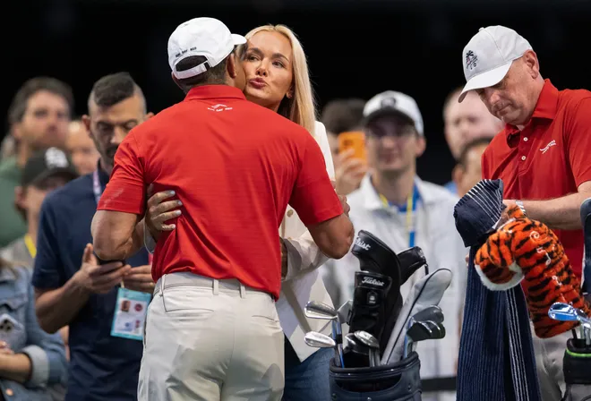 Tiger Woods of Jupiter Links GC gets a hug and kiss from Vanessa Trump before match against Los Angeles Golf Club during the TGL finals at SoFi Center on March 24, 2026, in Palm Beach Gardens, Fla.