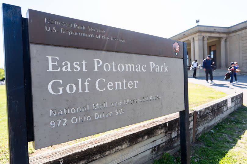 People walk past a sign at the entrance of East Potomac Golf Course, Sunday, May 3, 2026, in Washington. (AP Photo/Julia Demaree Nikhinson)