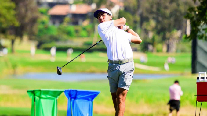 LSUMGolf060126_LSUAthletics Golfer in white shirt and cap mid-swing on a sunny golf course.