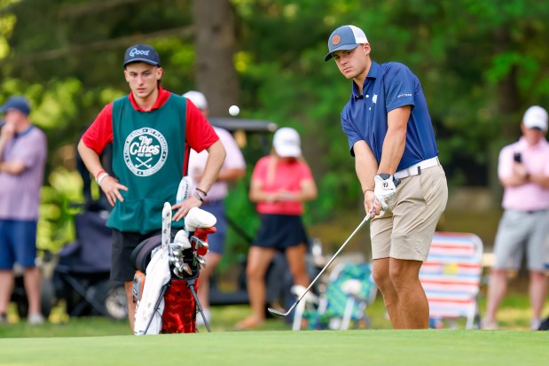 Trevor Drew of Long Meadow GC lofts a chip onto No. 13 as his caddie looks on during the final round of the 100th Lowell City Golf Tournament last June. He won by a staggering 13 shots. (James Thomas for the Lowell Sun)