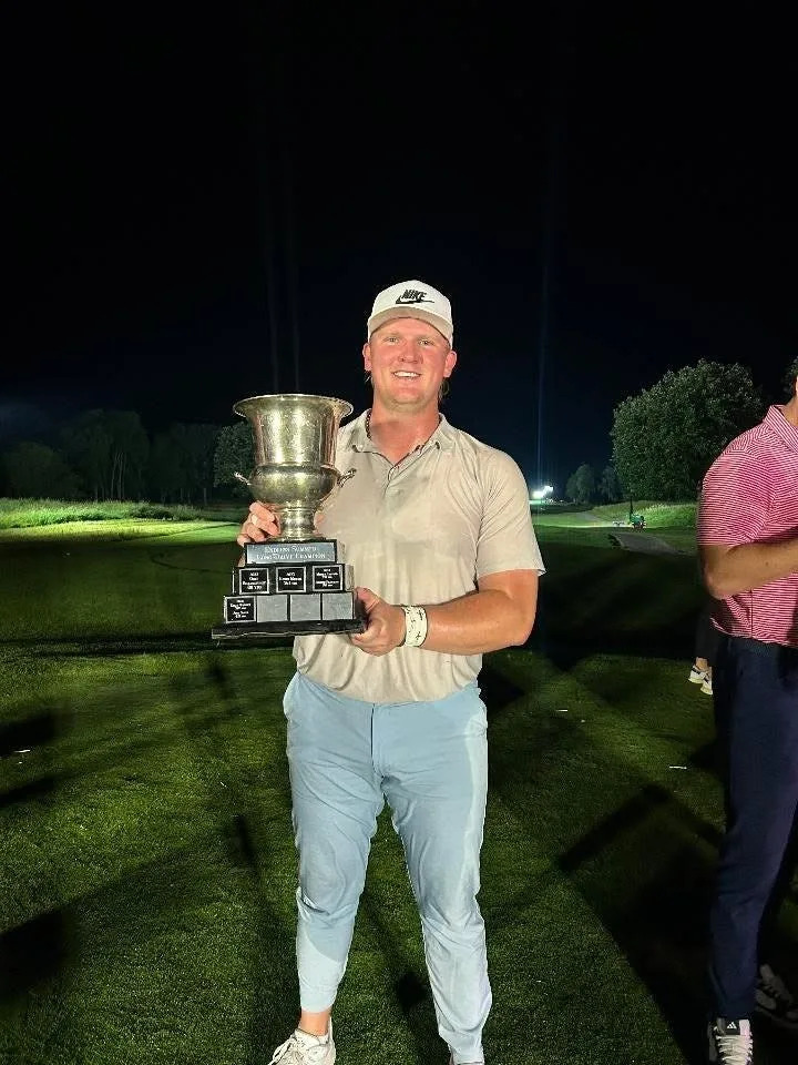 Former Roncalli high school boys golfer Logan Schott holds up his first-place trophy after winning the Endless Summer Long Drive Championship in Canada in June.