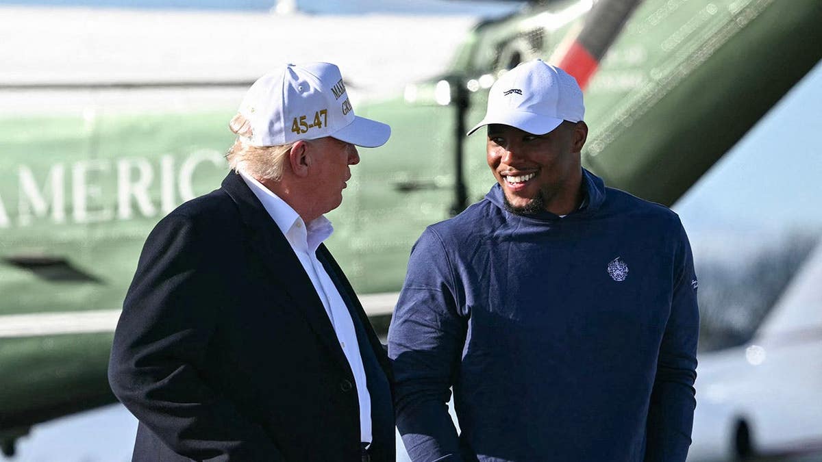 Donald Trump walks with Saquon Barkley before boarding Air Force One at Morristown Municipal Airport.