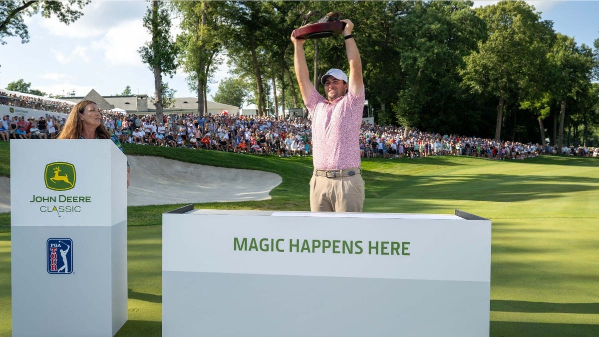 Chris Gotterup raises the trophy after winning the 2026 John Deere Classic at TPC Deere Run in Silvis, Illinois.