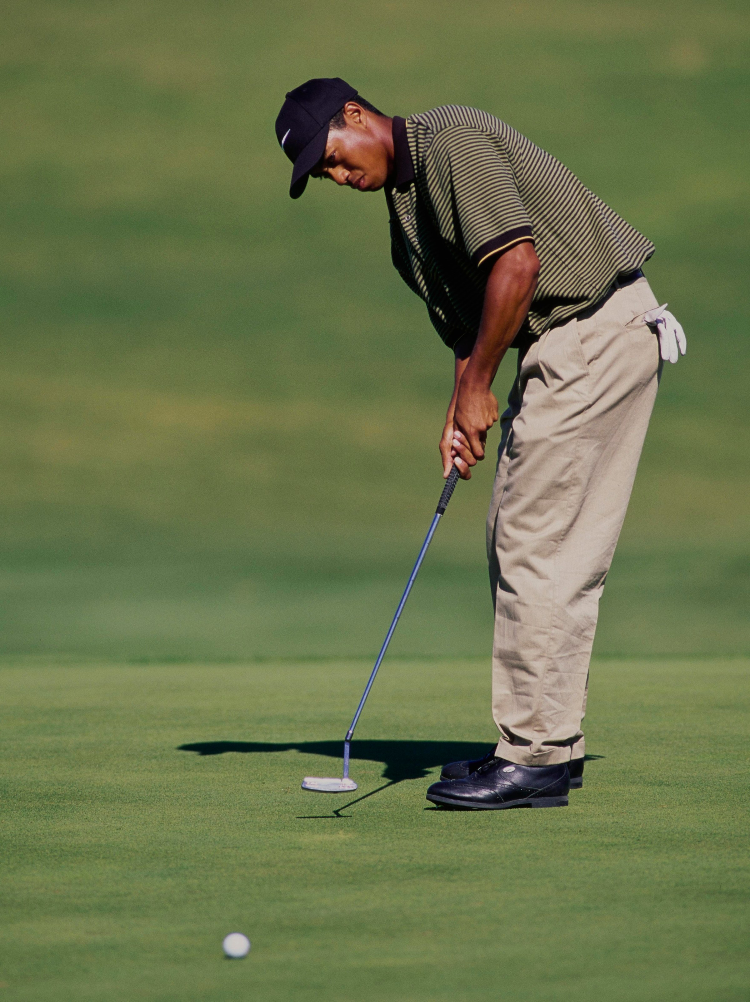 Tiger Woods follows his putt on the green at the PGA Las Vegas Invitational in 1996 at the TPC Summerlin Golf Course, Desert Inn, Las Vegas, Nevada.