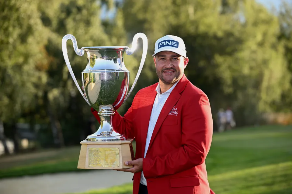 Thriston Lawrence celebrates winning the Omega European Masters with the trophy